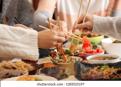 Friends Eating Tasty Chinese Food At Table