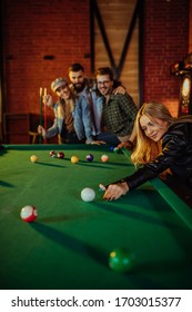 Friends Enjoying Billiard Game On Weekend Night