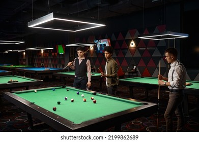 Friends Enjoying Billiard Game At Pool Hall