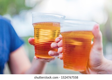 Friends Enjoying Drinking Beer In The Backyard.