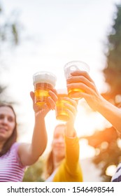 Friends Enjoying Drinking Beer In The Backyard.