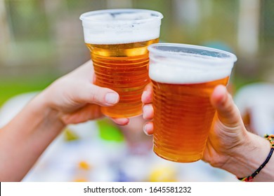 Friends Enjoying Drinking Beer In The Backyard.