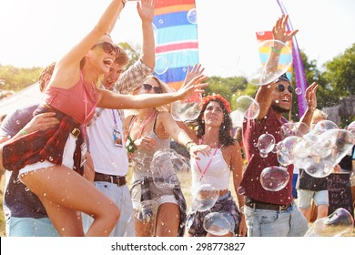 Friends enjoying a performance at a music festival - Shutterstock ID 298773827