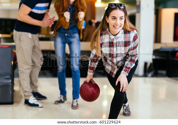 Friends enjoying\
recreational  bowling at\
club