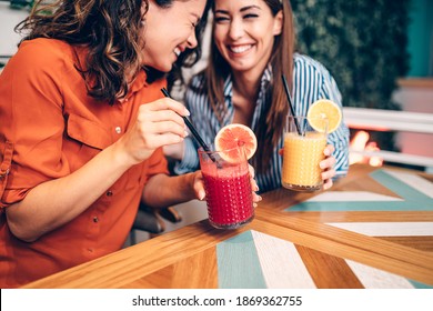 Friends enjoying together in restaurant. They are drinking a fresh beetroot and orange juice. - Powered by Shutterstock