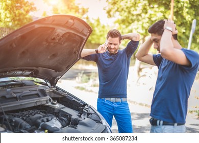 Friends examining broken down car on sunny day - Powered by Shutterstock