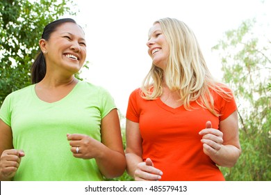 Friends Exercising And Walking Outside Together.  Women Getting Fit.