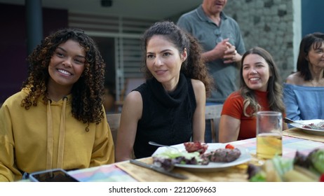 Friends And Family Gathered Together For Barbecue In Home Backyard Party. People Celebrating Life Toasting With Drinks