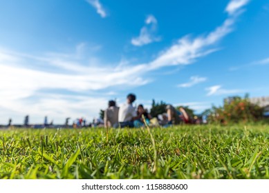 Friends and family having fun on a picnic on the lawn with bright blue sky. selectes focus. - Powered by Shutterstock