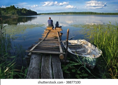 friends or father and son fishing on the lake - Powered by Shutterstock