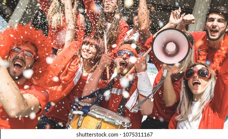 Friends Football Supporter Fans Cheering With Confetti Watching Soccer Match Event At Stadium - Young People Group With Red T-shirts Having Excited Fun On Sport World Championship Concept