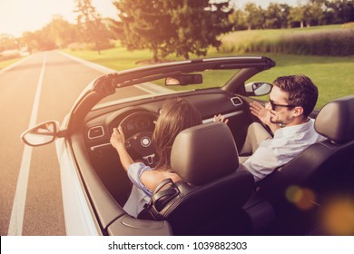 Friends, friendship, destination, auto vehicle rent, escape, speed ride. Rear back shot of carefree wife driver with arms rudder and henpecked husband on way to honeymoon, sunshine, sunlight, light