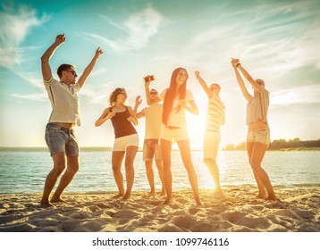 Friends Funny Dance On The Beach Under Sunset Sunlight. Sunny Day And Friendship.