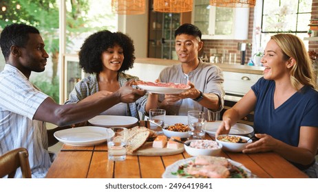 Friends Gather Around the Table to Enjoy a Delicious Meal Together in a Cozy Home Setting - Powered by Shutterstock