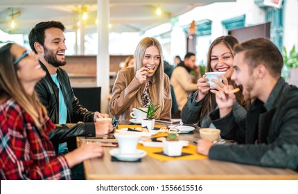 Friends group drinking cappuccino at coffee bar - People talking and having fun together at fancy cafeteria - Friendship concept with happy guys and girls at restaurant cafe - Warm bulb light filter - Powered by Shutterstock