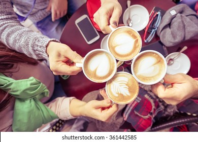 Friends group drinking cappuccino at coffee bar restaurant - People hands cheering and toasting on upper view point - Social gathering concept with men and women together - Vintage marsala filter - Powered by Shutterstock