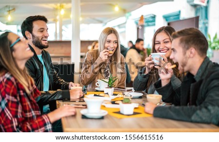 Friends group drinking cappuccino at coffee bar - People talking and having fun together at fancy cafeteria - Friendship concept with happy guys and girls at restaurant cafe - Warm bulb light filter