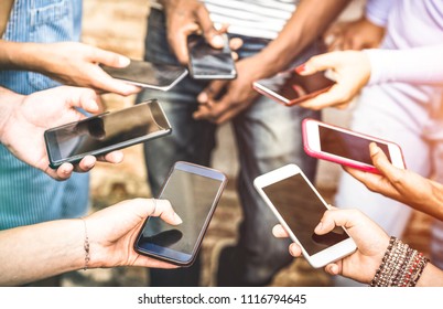Friends group having addicted fun together using smartphones - Hands detail sharing content on social network with mobile smart phone - Technology concept with people millennials online with cellphone
