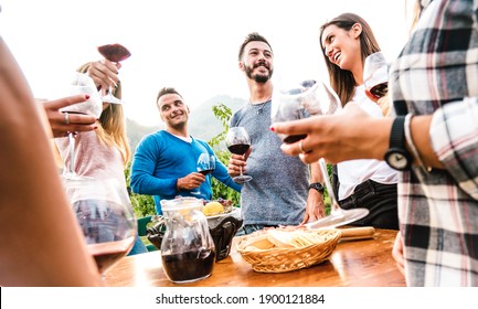 Friends Group Having Fun Together At Garden Party - Young People Enjoying Harvest Time Drinking Red Wine At Farm House Vineyard - Friendship Concept With Men And Women Outside On Warm Sunset Filter