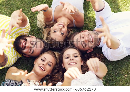 Similar – Young people with their heads together having fun