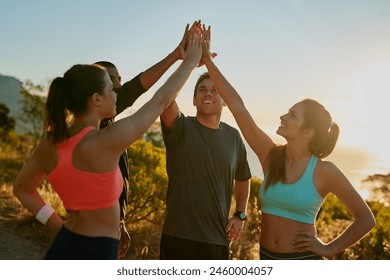 Friends, group and high five for running exercise on mountain for park trail, support or fitness. Men, women and hand gesture for training goals or sport target with celebration, morning or nature - Powered by Shutterstock