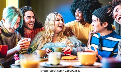 Friends group laughing together at coffee bar - Young people talking and having fun at cappuccino restaurant - Life style concept with diverse guys and girls at cafe breakfast venue - Vivid filter - Powered by Shutterstock