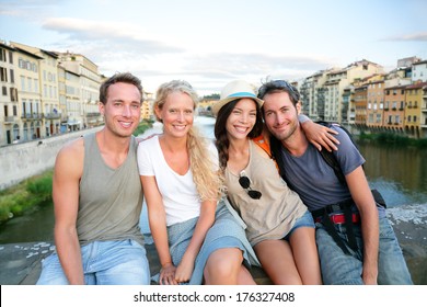 Friends - Group Of People On Travel Vacation Having Fun Together. Two Couples Traveling In Florence, Tuscany, Italy, Europe.