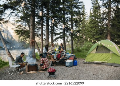 Friends hanging out at lakeside campsite - Powered by Shutterstock