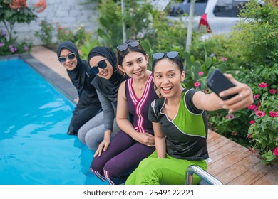 Friends happily capturing special memories together by the poolside on a bright sunny day - Powered by Shutterstock