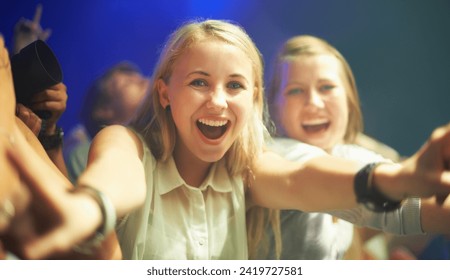 Friends, happy or selfie at concert in portrait, bonding or excited for social fun at music festival. Women, together or smile on face at live show, event or celebration in crowd at disco performance - Powered by Shutterstock