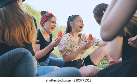 Friends Have Fun Eating Watermelon Outside The City At A Picnic.