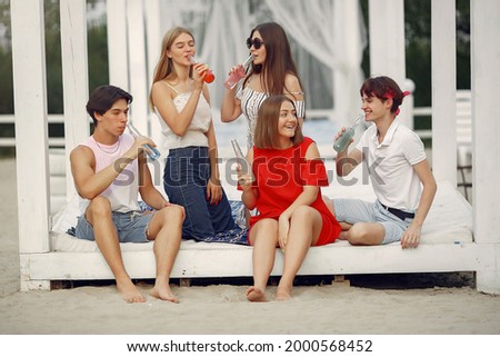 Similar – Young friends holding woman on top of surfboard