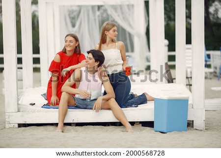 Similar – Young friends holding woman on top of surfboard