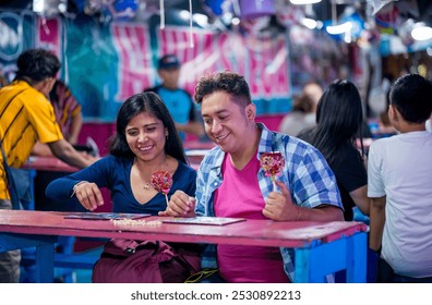 Friends have visited the fair and are preparing to play the lottery. They are sitting and around them people are seen playing as well. - Powered by Shutterstock