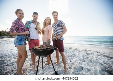 Friends Having A Barbecue At The Beach