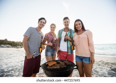 Friends Having A Barbecue At The Beach