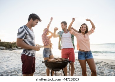 Friends Having A Barbecue At The Beach