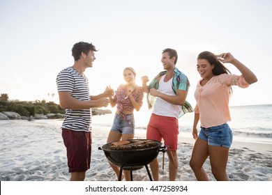 Friends Having A Barbecue At The Beach