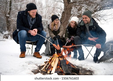 Friends having barbecue on a snowy day