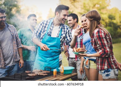 Friends having a barbecue party in nature  while having a blast - Shutterstock ID 607634918