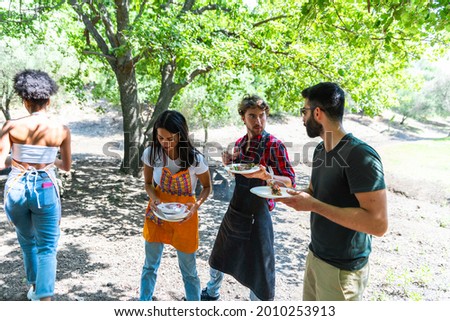 Similar – Gruppe von Freunden, die bei einem Sommergrill kochen.