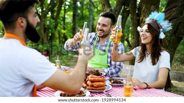 Friends having a\
barbecue party in\
nature