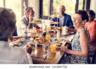 Friends having breakfast at a hotel - Powered by Shutterstock