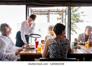 Friends having breakfast at a hotel - Powered by Shutterstock