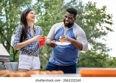 Friends Having Burgers At A Tailgate Party