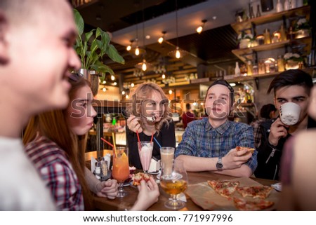 friends having a coffee together. women and man at cafe, talking, laughing and enjoying their time. Lifestyle and friendship concepts with real people models.