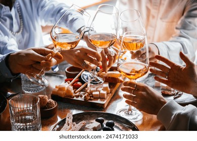 Friends having a dinner party with different kinds of appetizers and rose wine. - Powered by Shutterstock