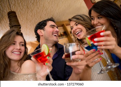 Friends having drinks at the club looking very happy
