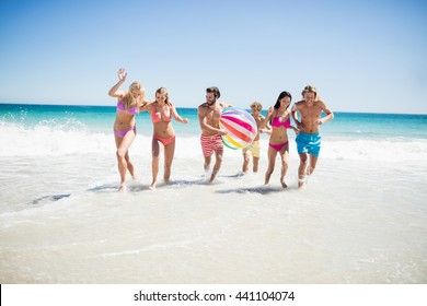 Friends Having Fun At The Beach On A Sunny Day