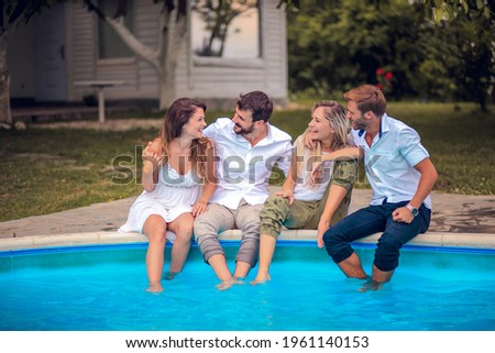 Similar – Young friends holding woman on top of surfboard